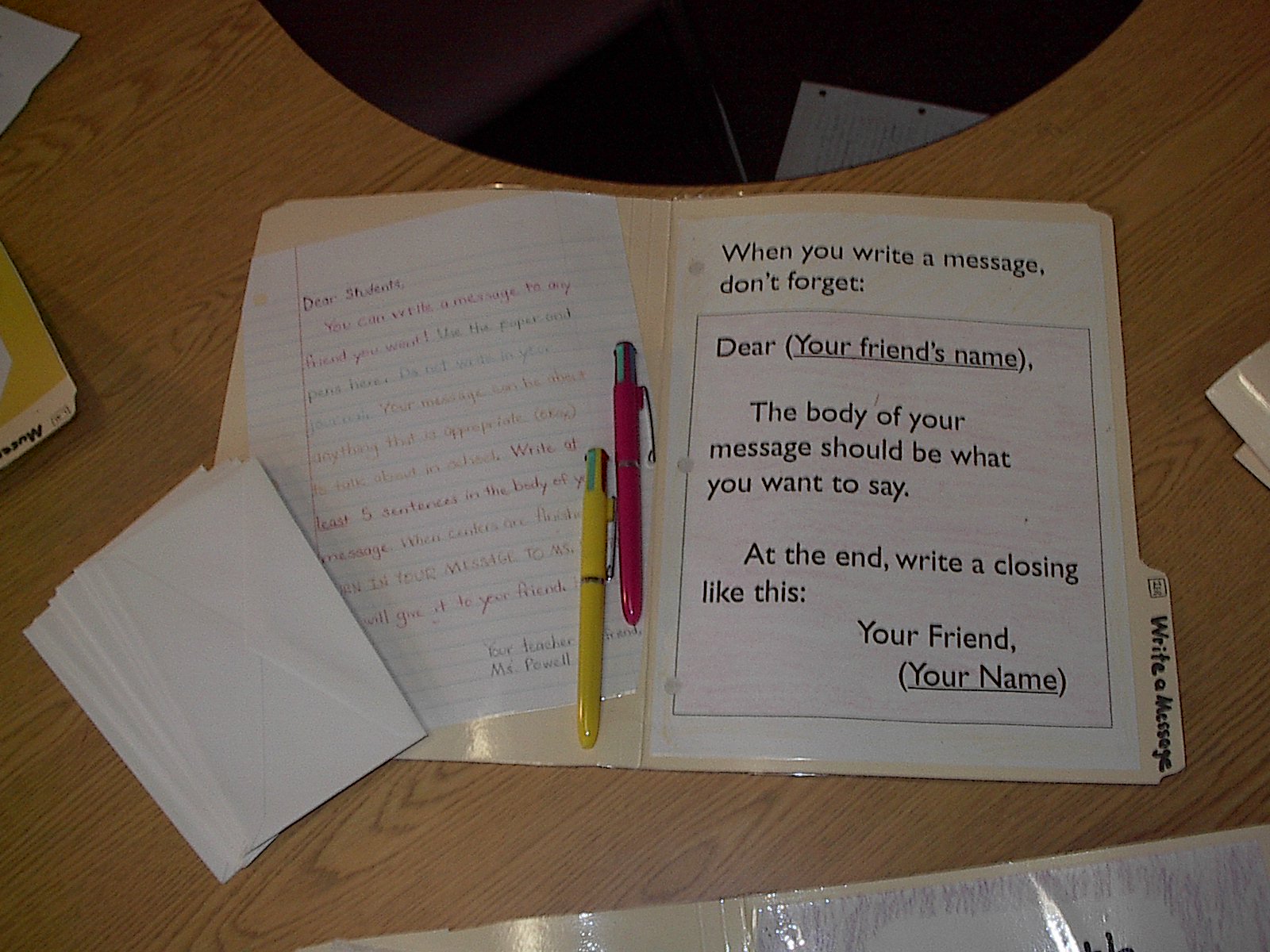 Write a Message: The focus here is writing for a meaningful purpose. Many students only write in school, and because they have to–this is an opportunity to show them that writing can be fun and useful in their own lives,. They can write a letter to whoever they want, and after showing it in to me after center time, can give it to that person. Students use different colored ink pens, which makes it really fun!  The left side of the folder demonstrates proper letter writing format, which I insist on towards the end of the year, although I allow casual notes in the beginning. You could also use this center for formal/business letter practice.